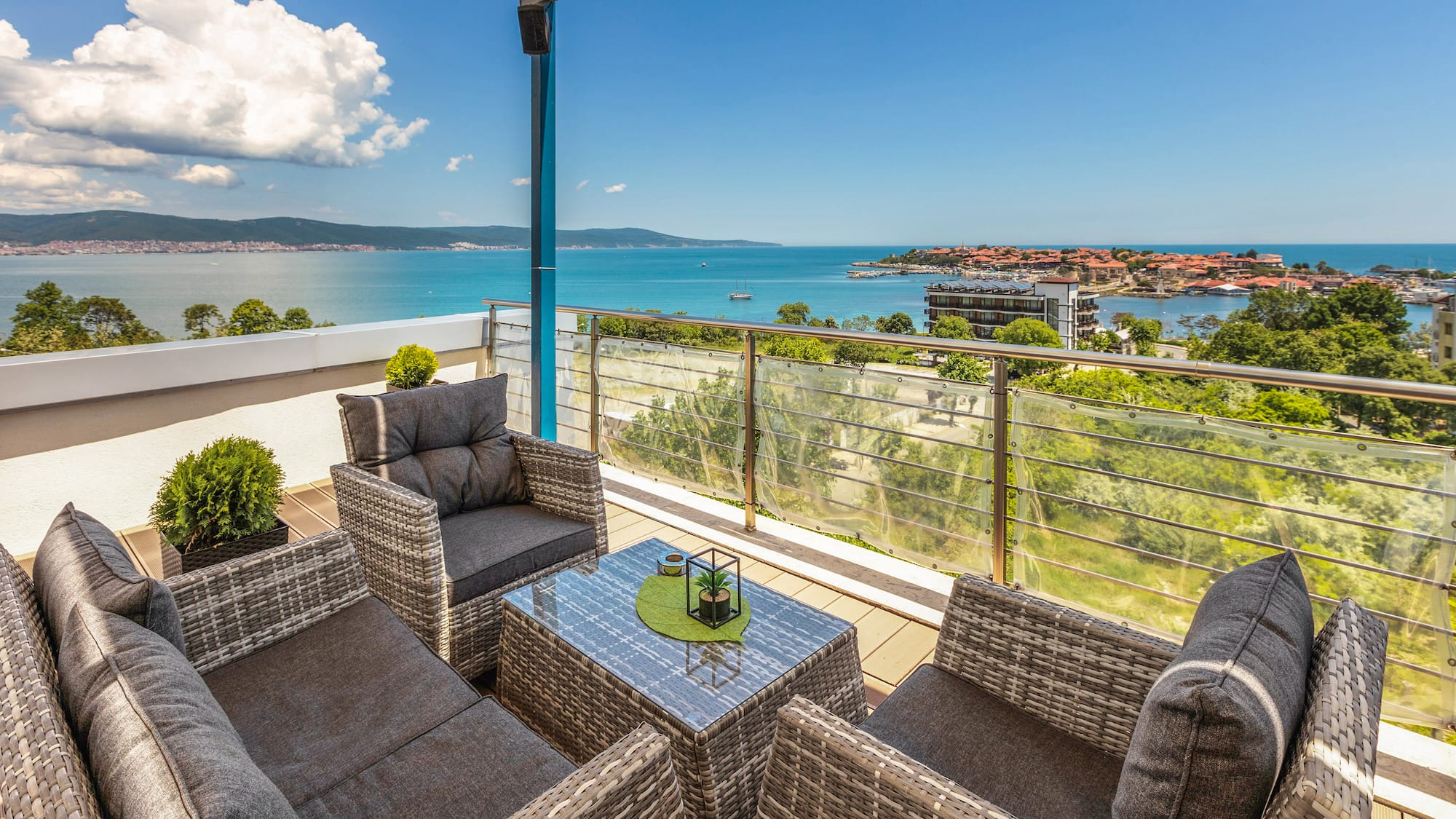 a patio with chairs and a table overlooking water
