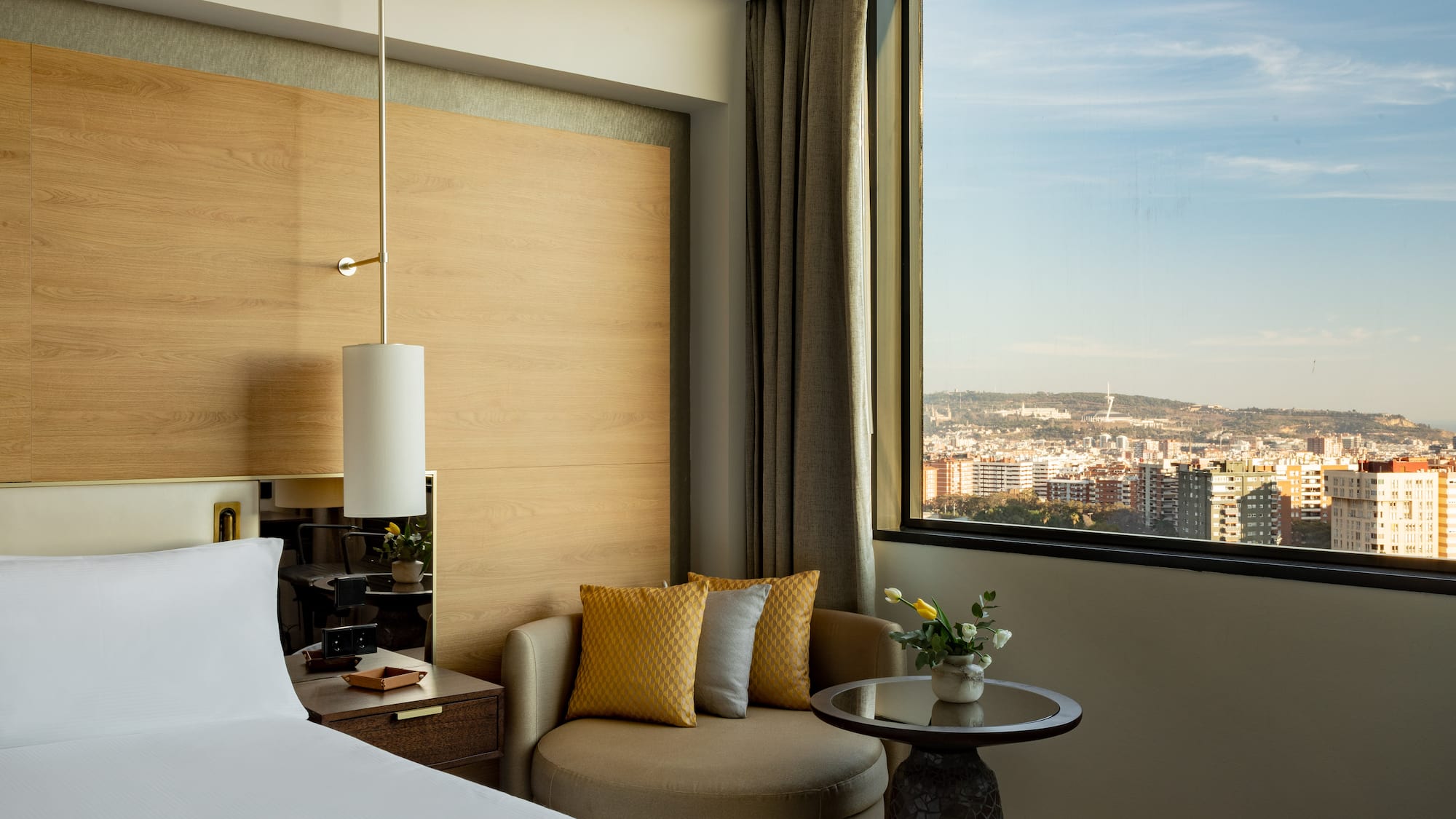 a room with a bed and a chair and a table