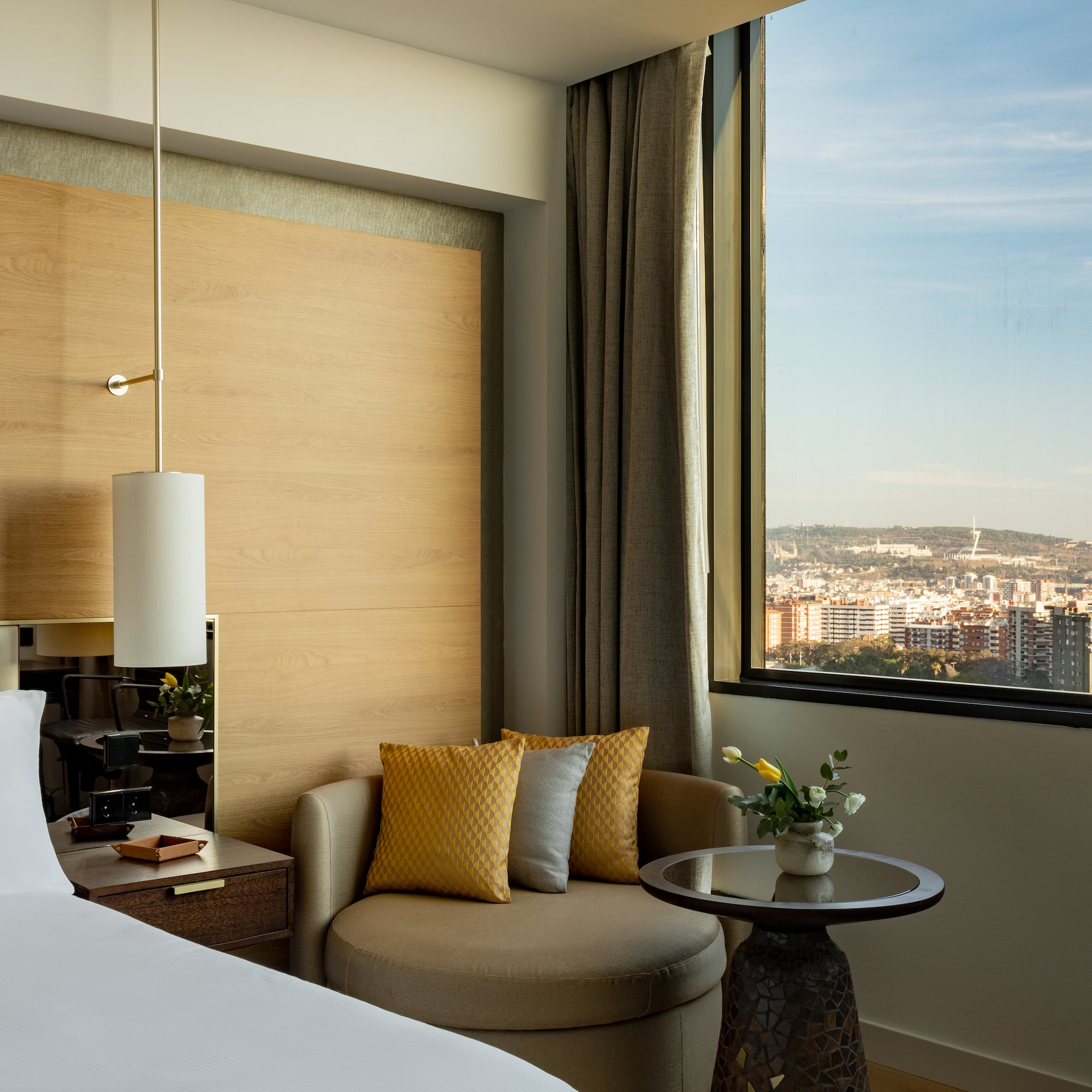 a room with a bed and a chair and a table