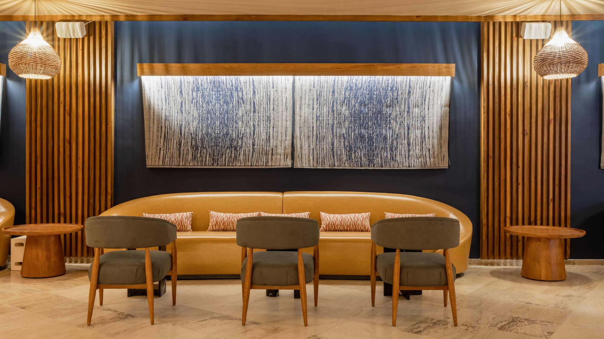 a room with a couch and chairs