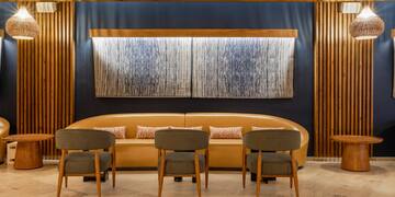 a room with a couch and chairs