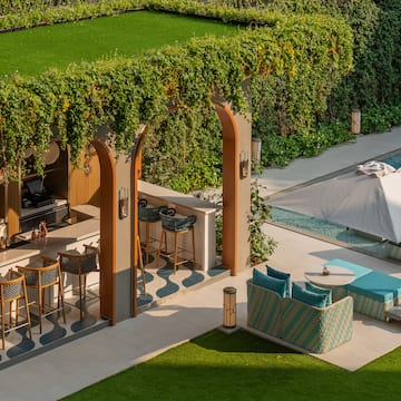 a patio with chairs and a pool