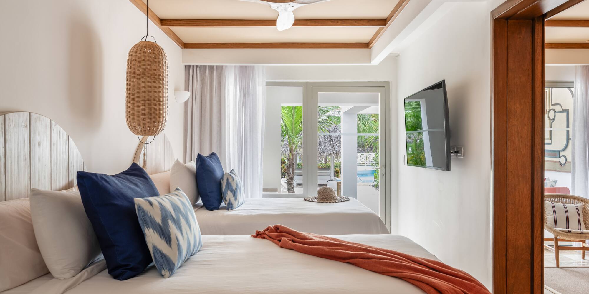 a room with two beds and a ceiling fan