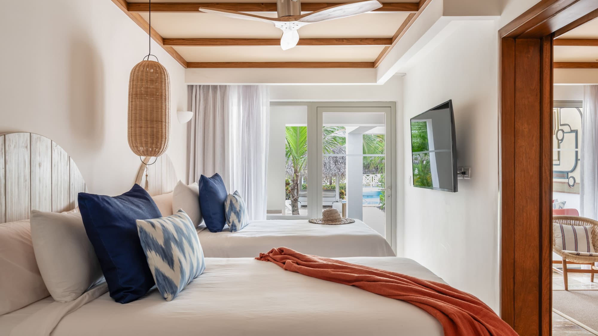 a room with two beds and a ceiling fan