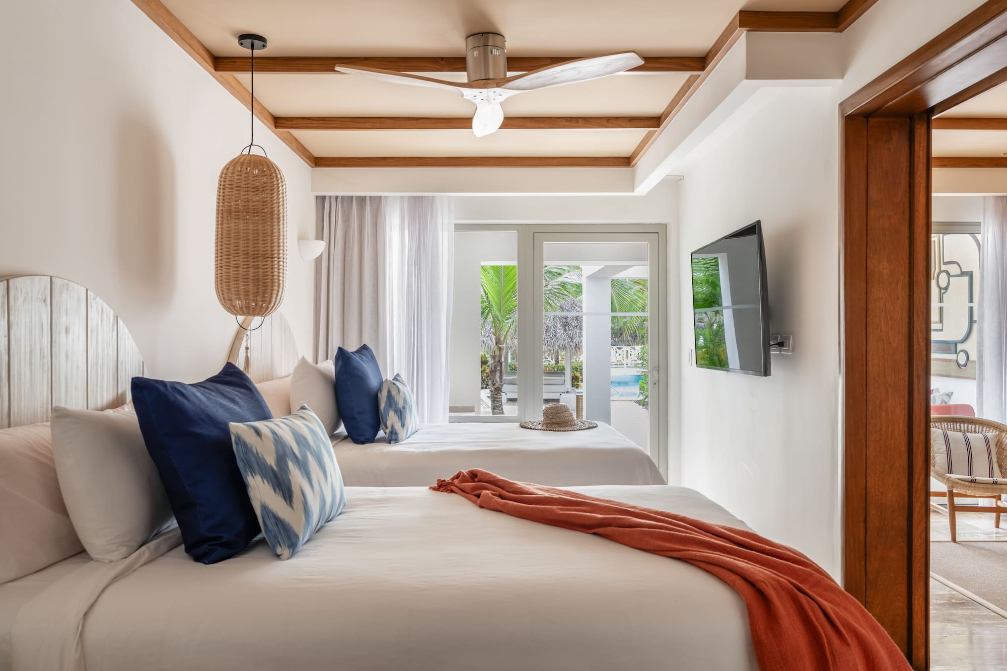 a room with two beds and a ceiling fan