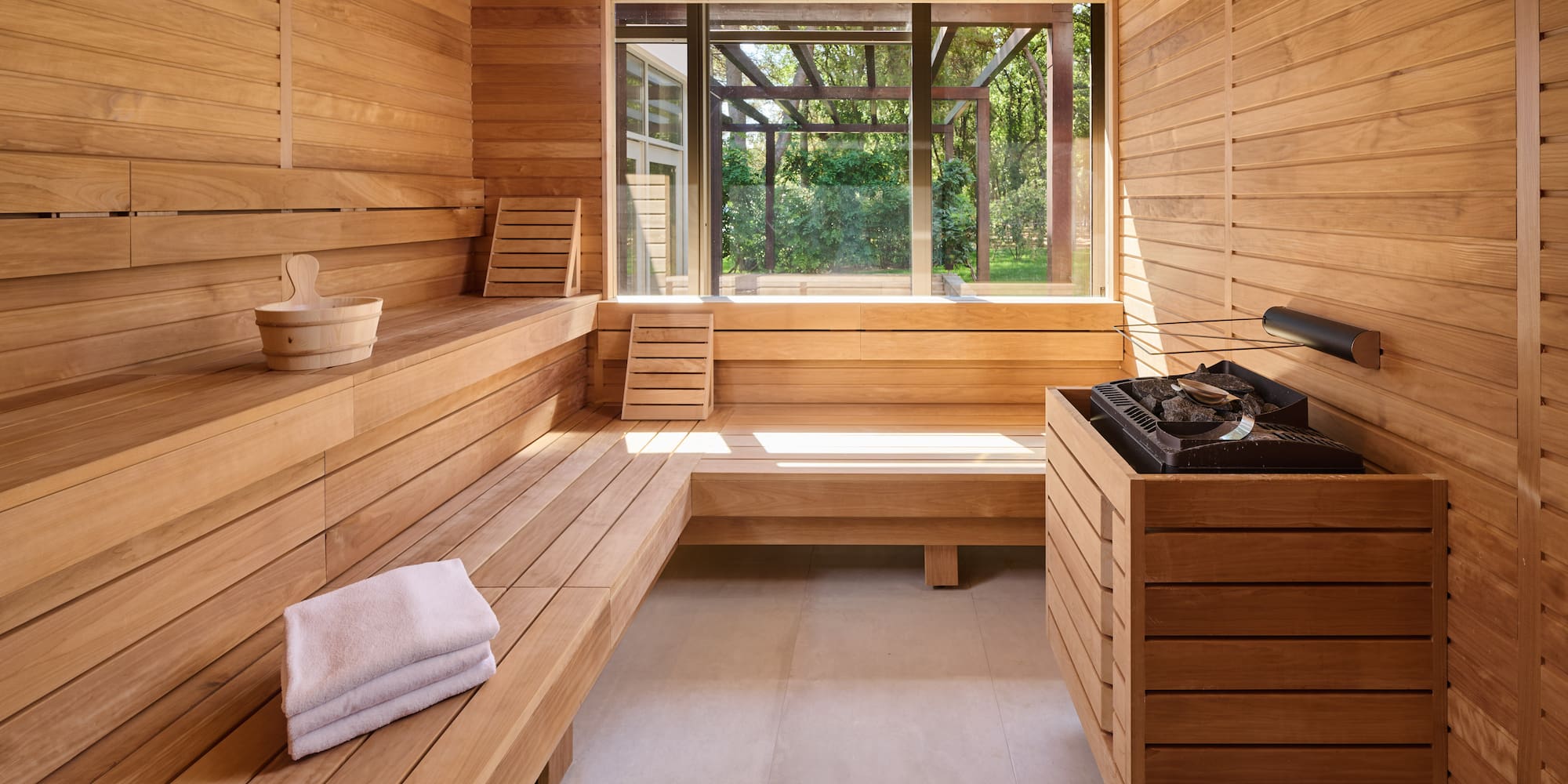 a sauna with a bench and a grill