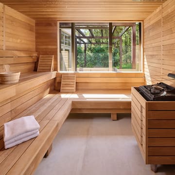 a sauna with a bench and a grill