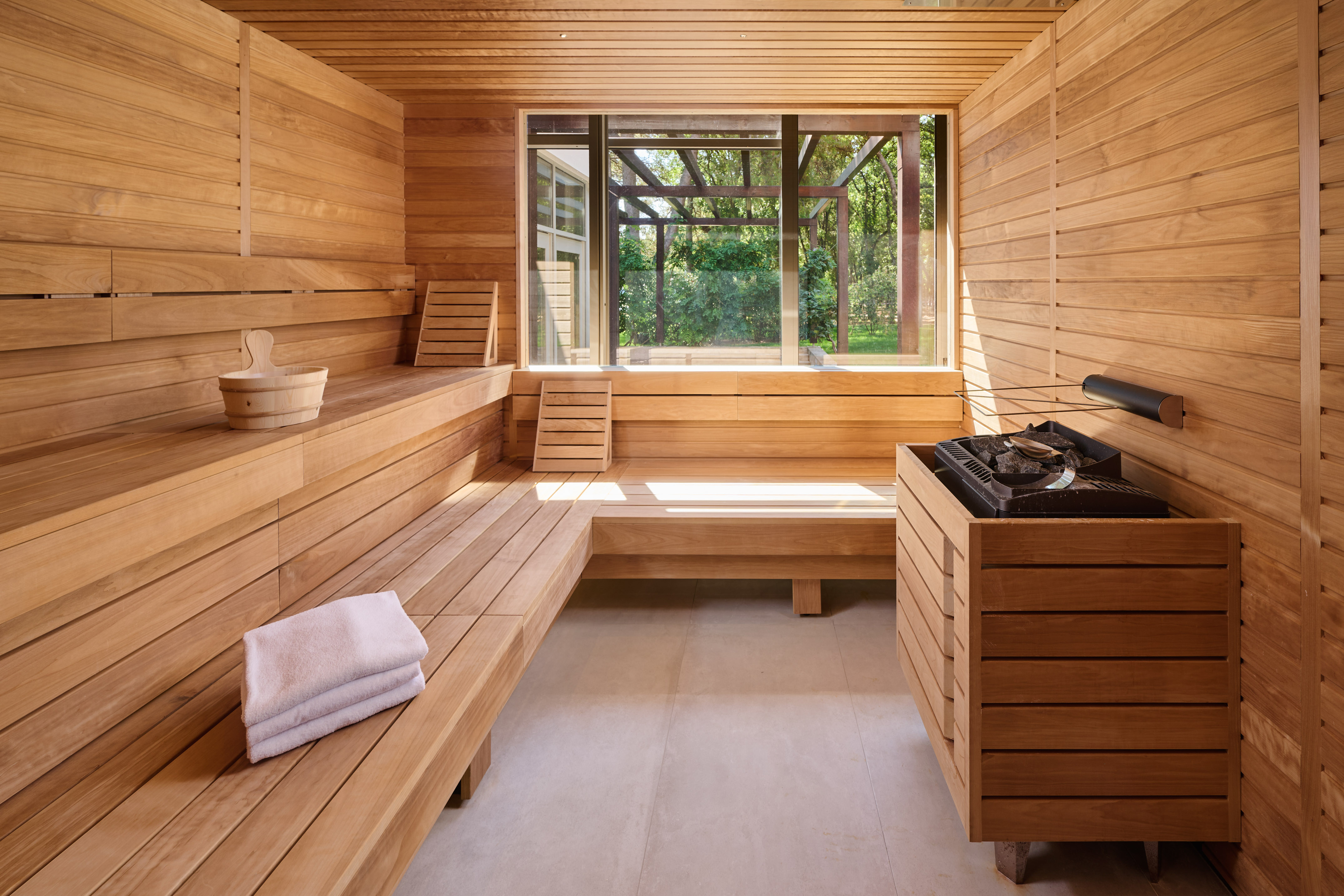 a sauna with a bench and a grill