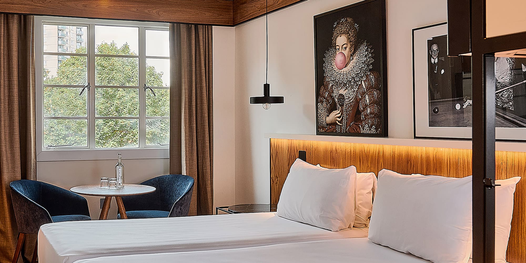 a room with two beds and a table and chairs