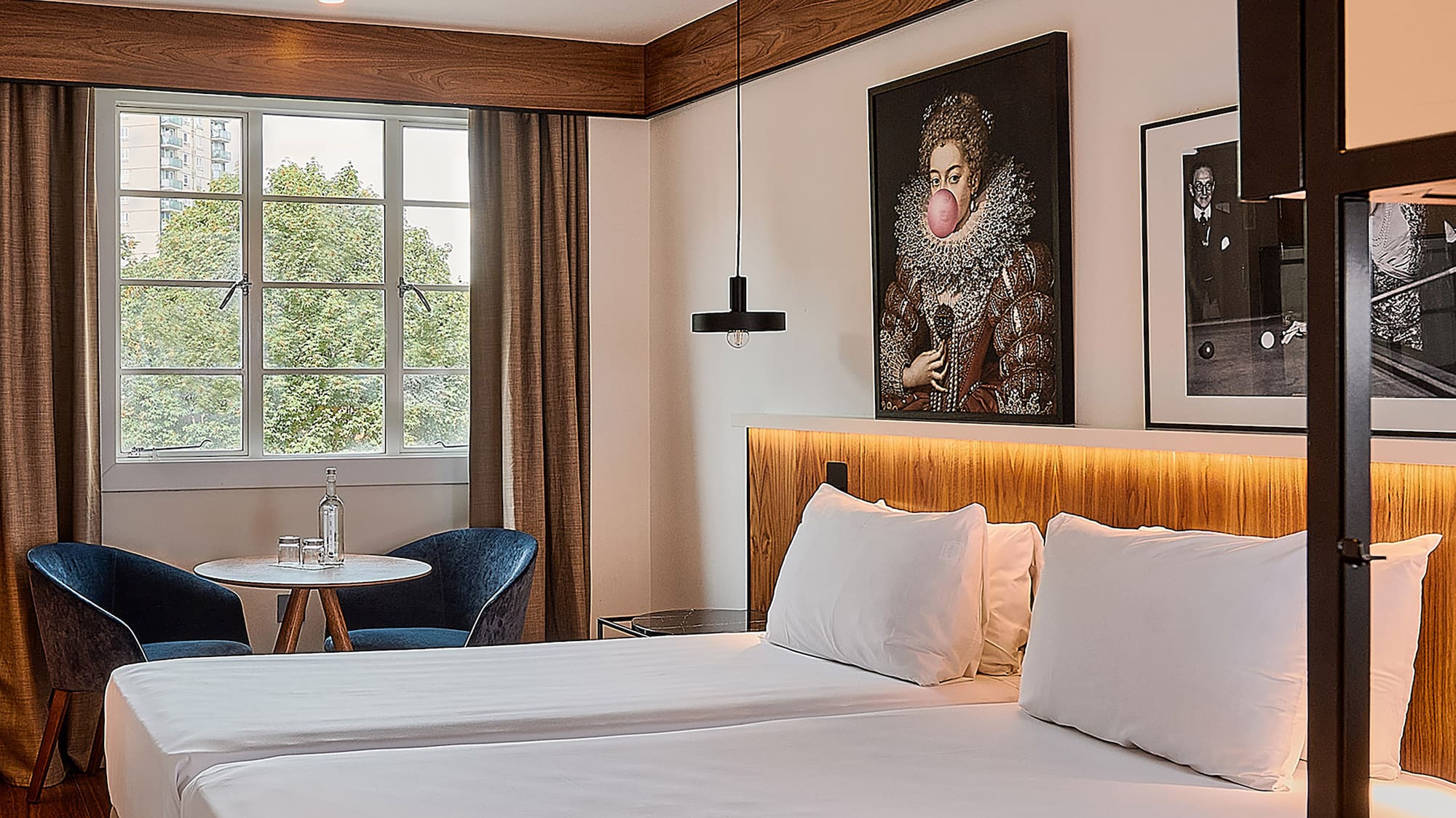 a room with two beds and a table and chairs