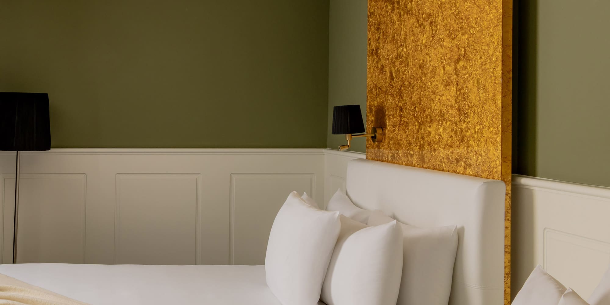 a room with two beds and a lamp