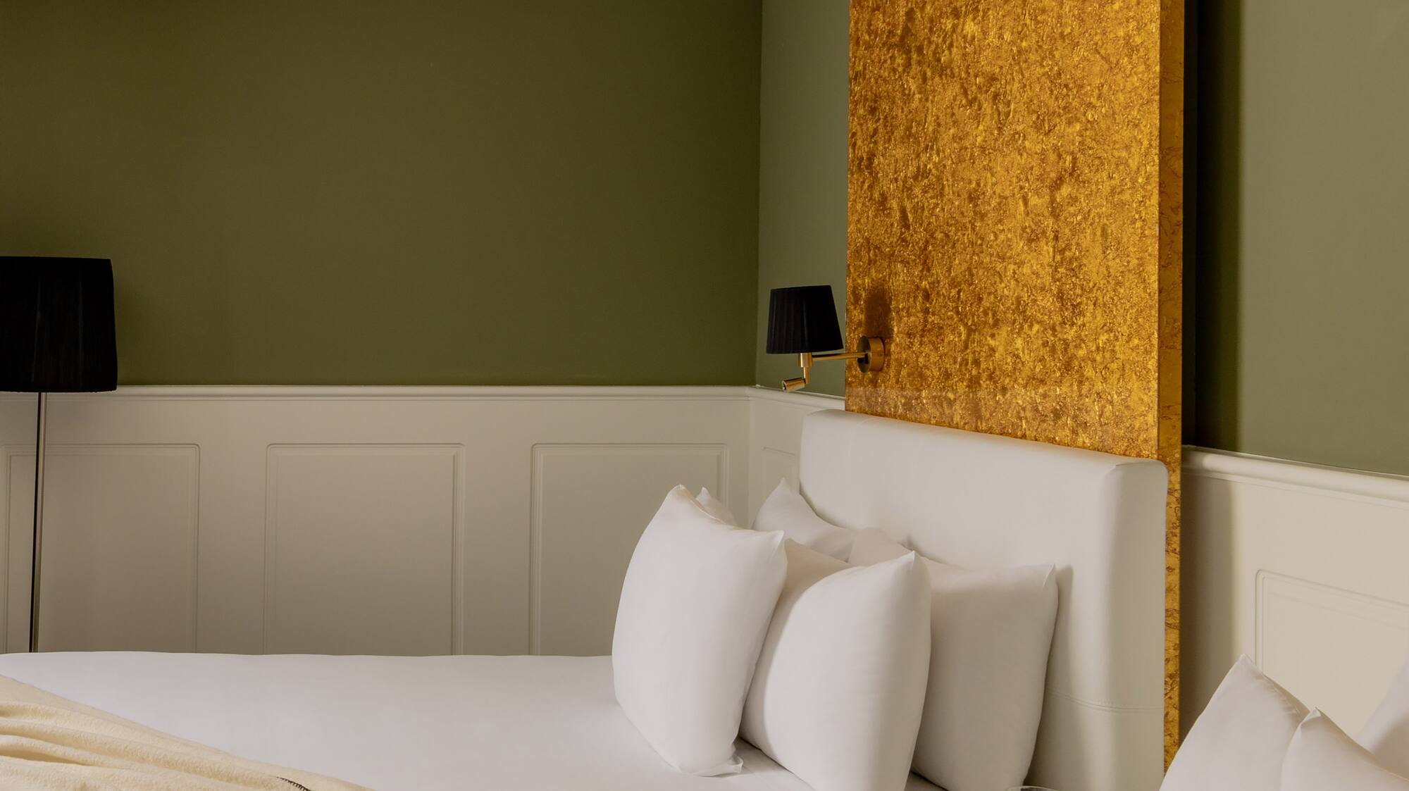 a room with two beds and a lamp