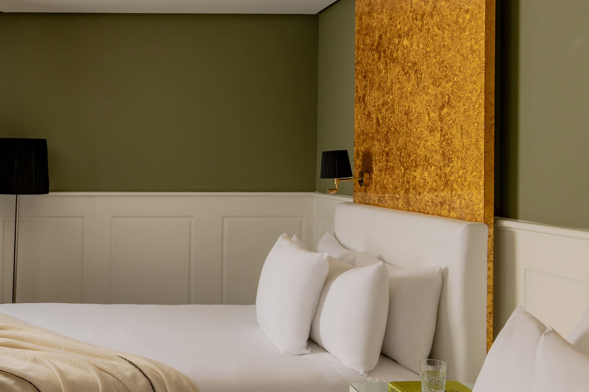 a room with two beds and a lamp