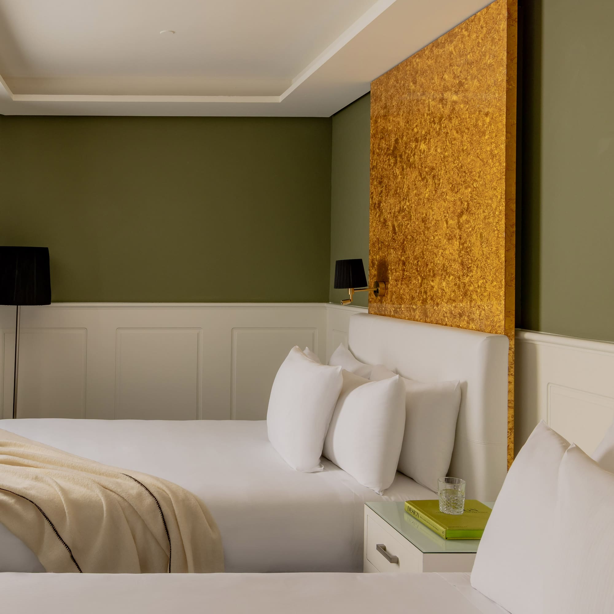 a room with two beds and a lamp