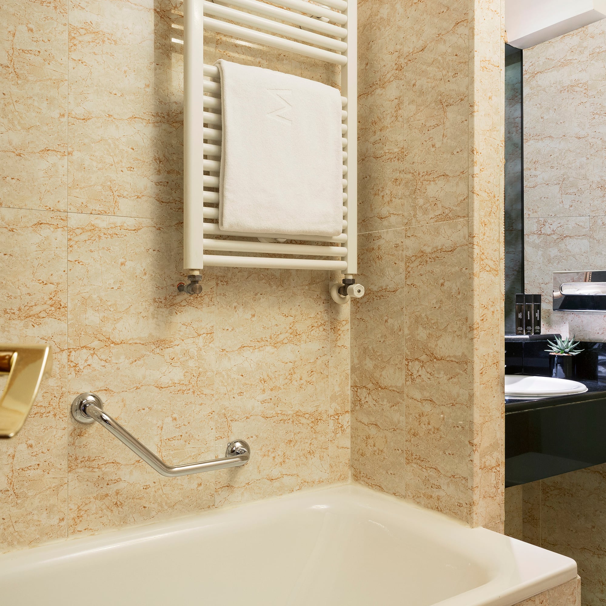 a bathroom with a bathtub and a towel rack