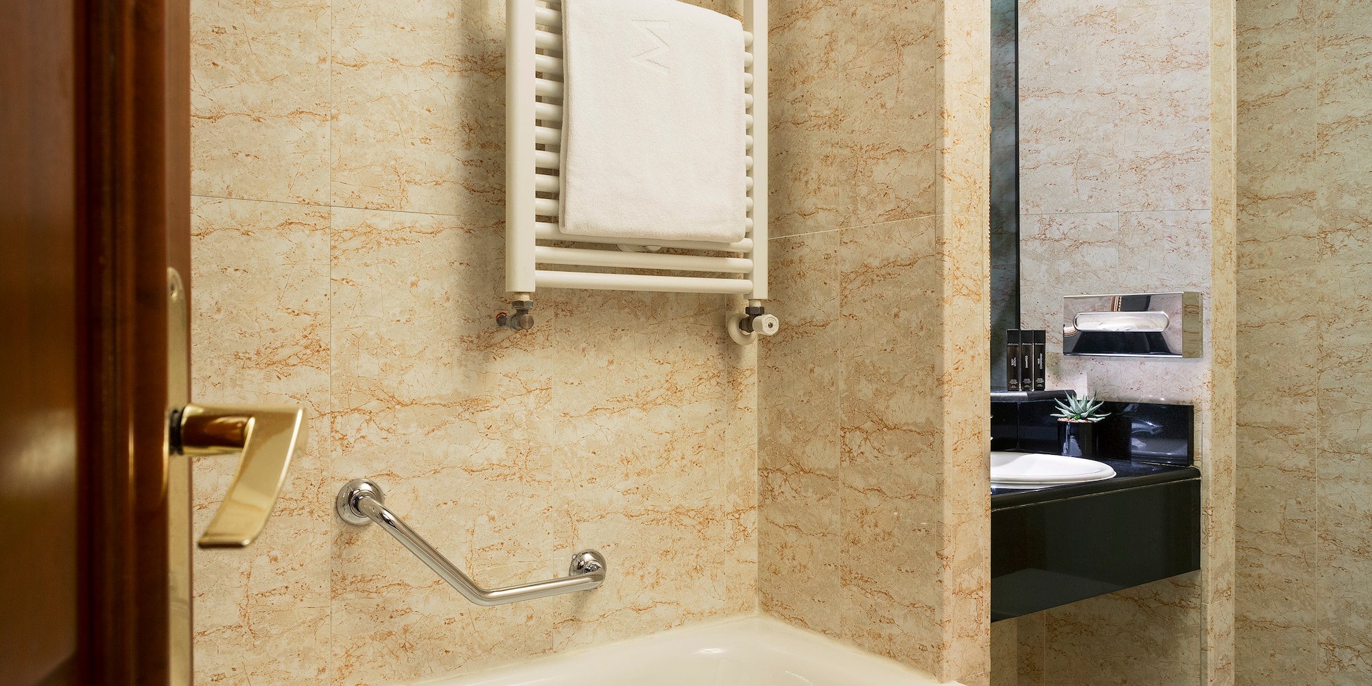 a bathroom with a bathtub and a towel rack