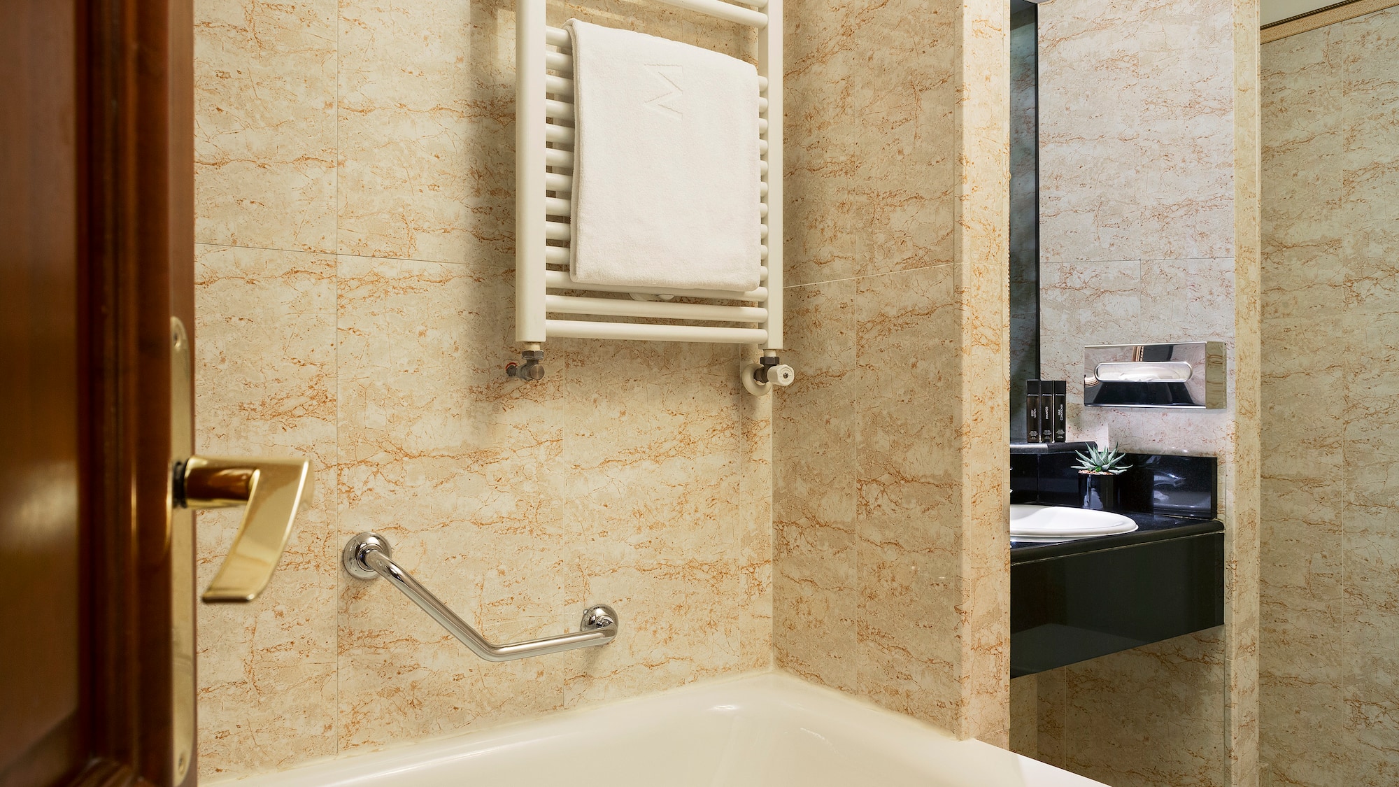a bathroom with a bathtub and a towel rack