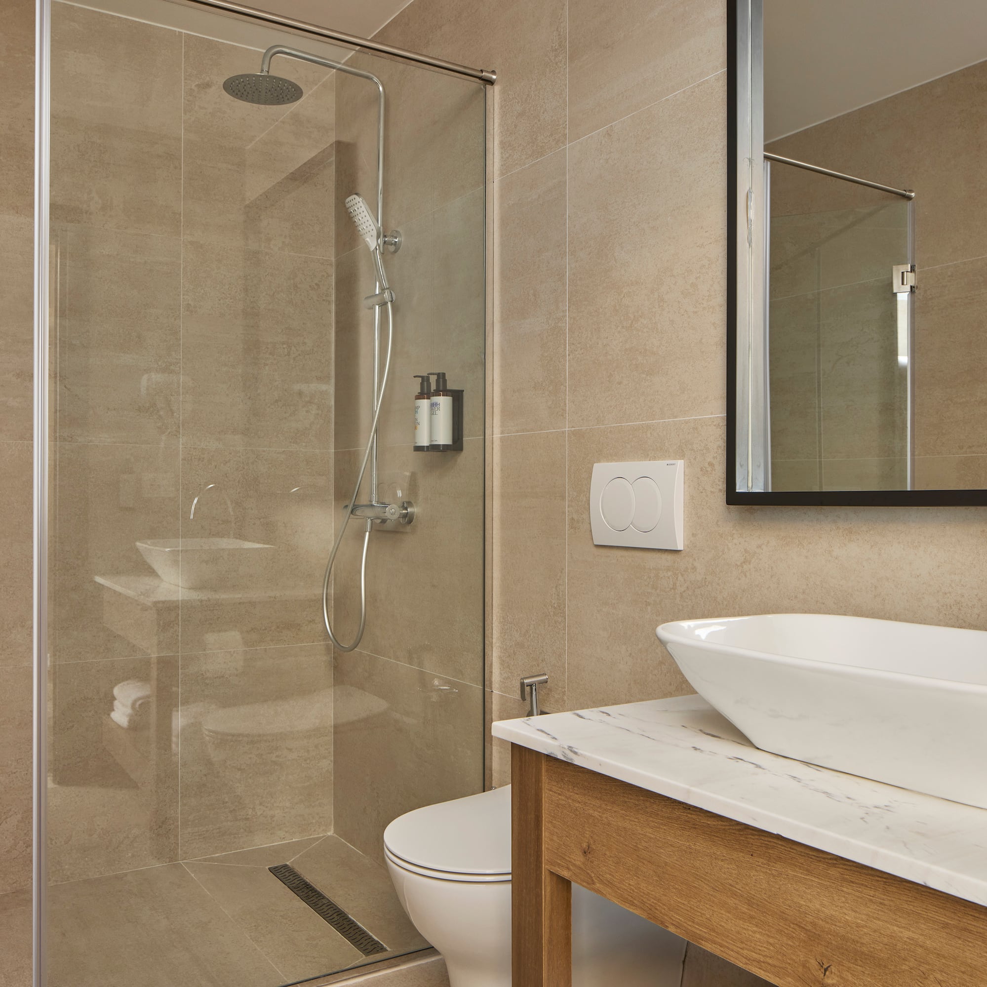 a bathroom with a glass shower and sink