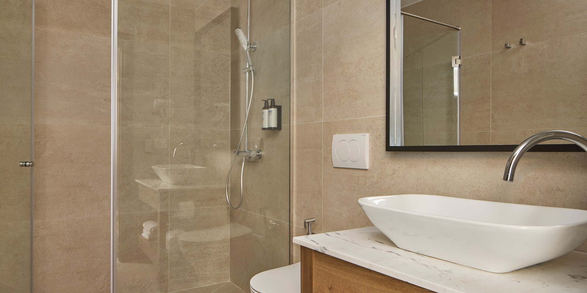 a bathroom with a glass shower and sink