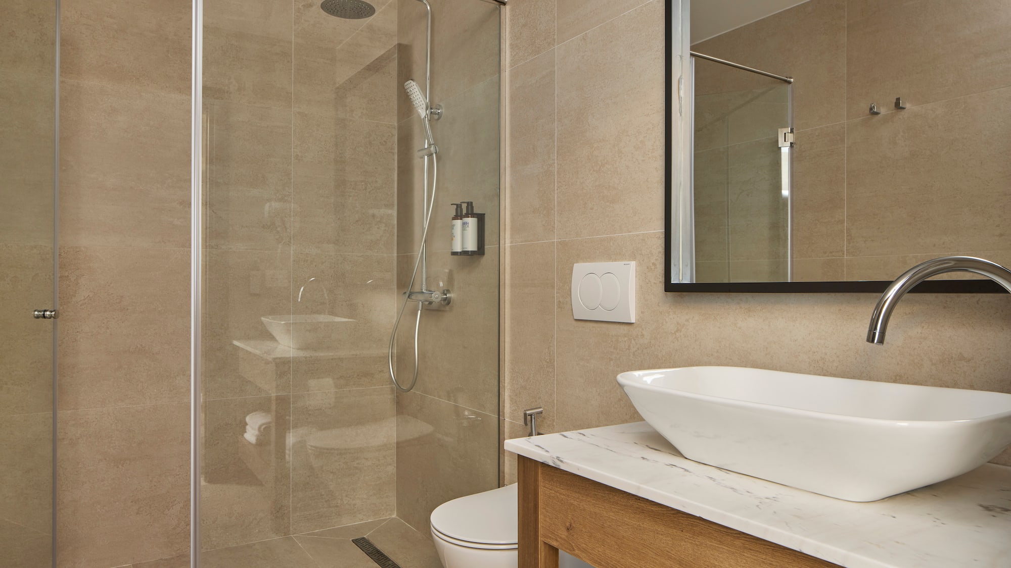a bathroom with a glass shower and sink
