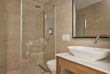 a bathroom with a glass shower and sink