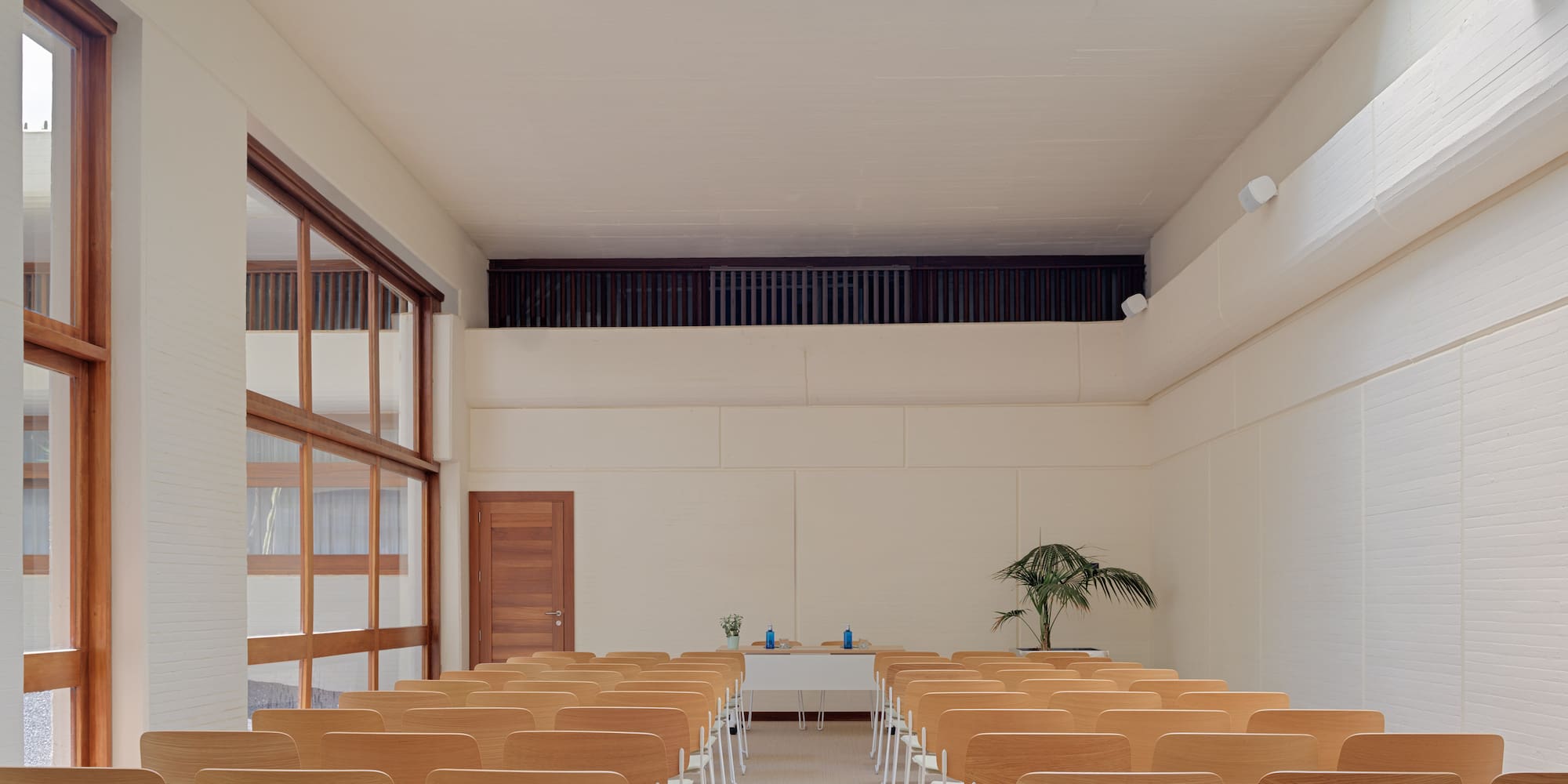 a room with many chairs and a skylight
