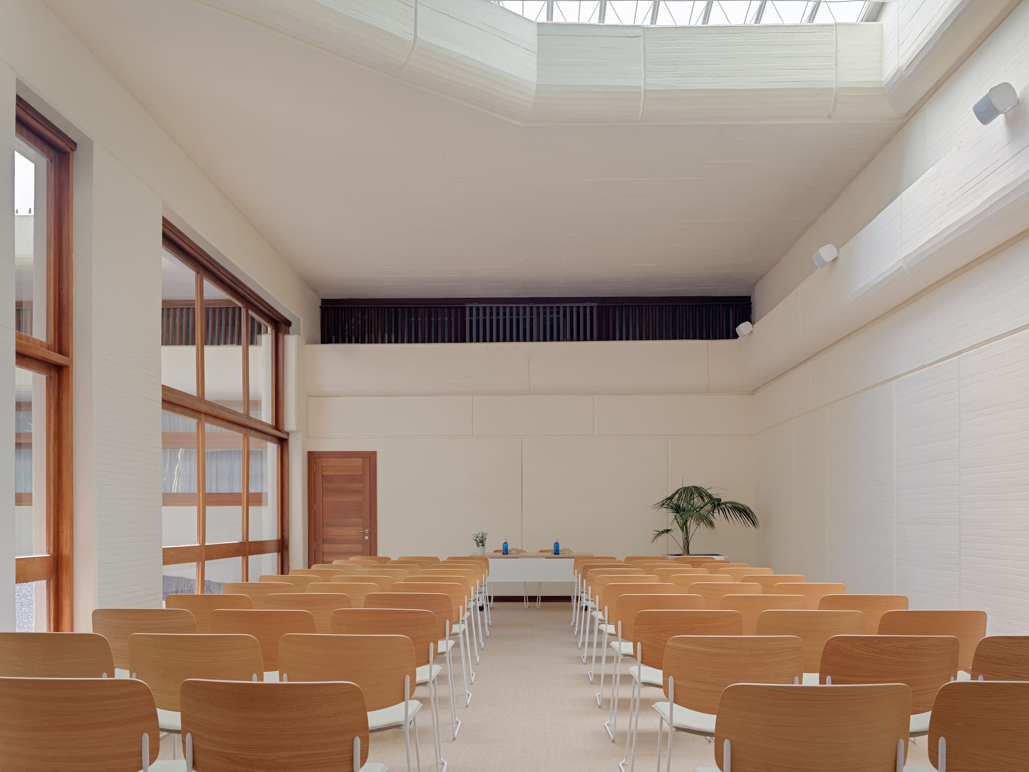 a room with many chairs and a skylight