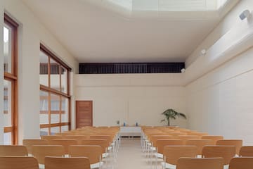 a room with many chairs and a skylight