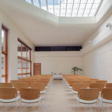 a room with many chairs and a skylight