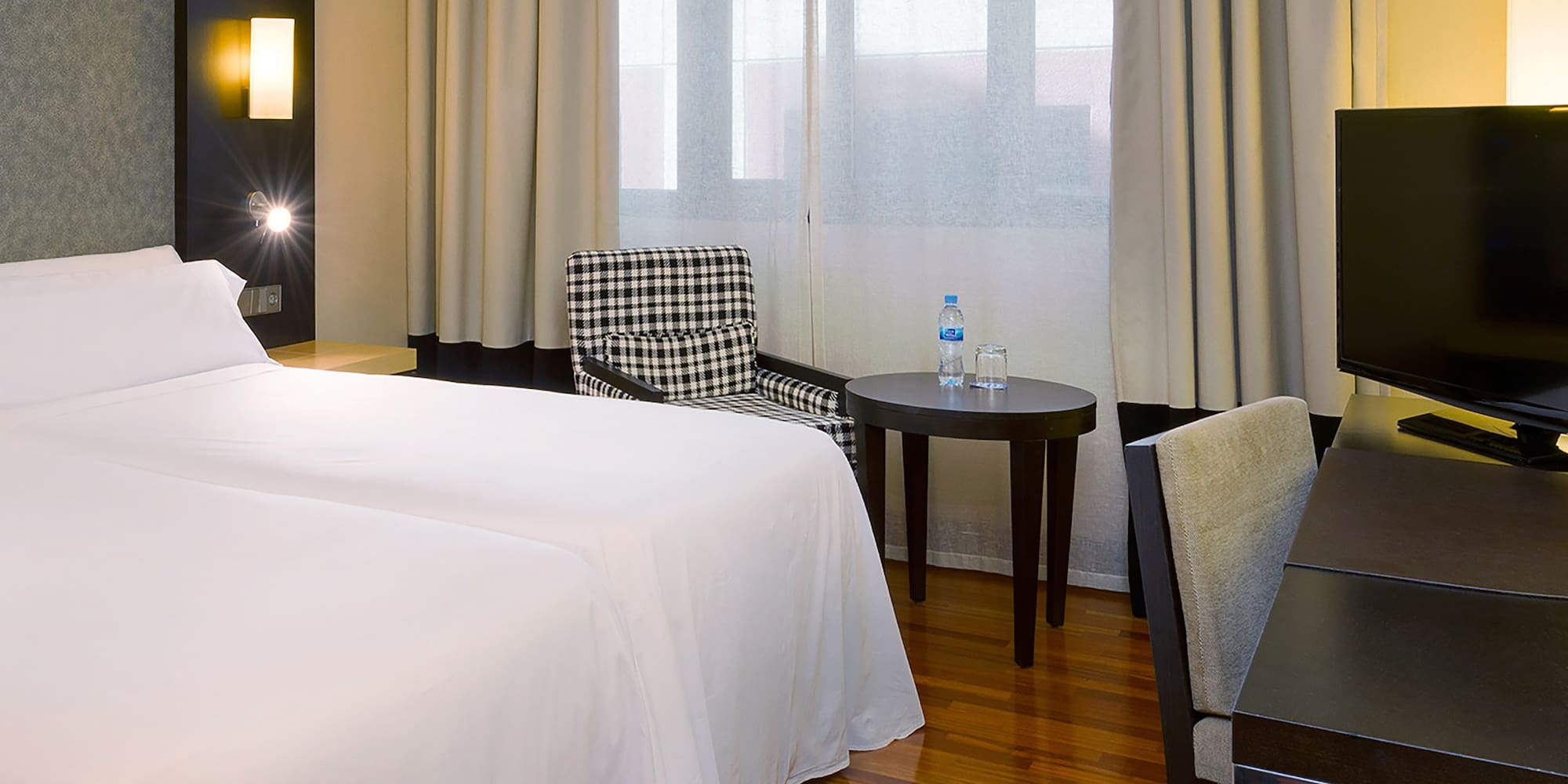 a room with a bed and a table and chairs