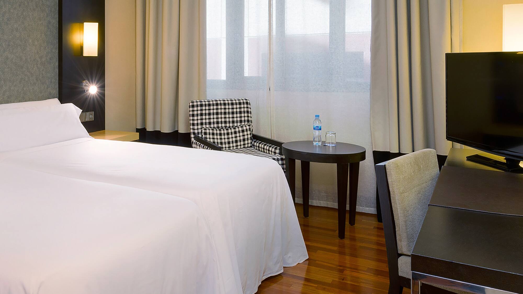 a room with a bed and a table and chairs