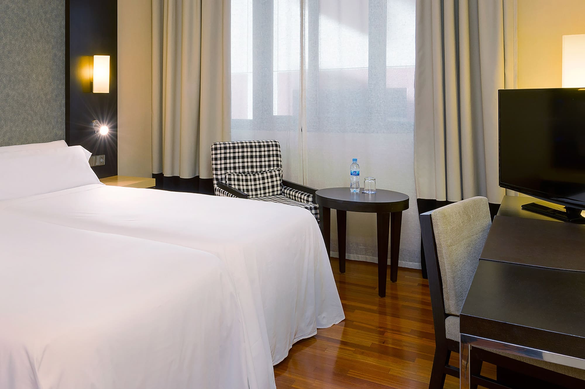 a room with a bed and a table and chairs