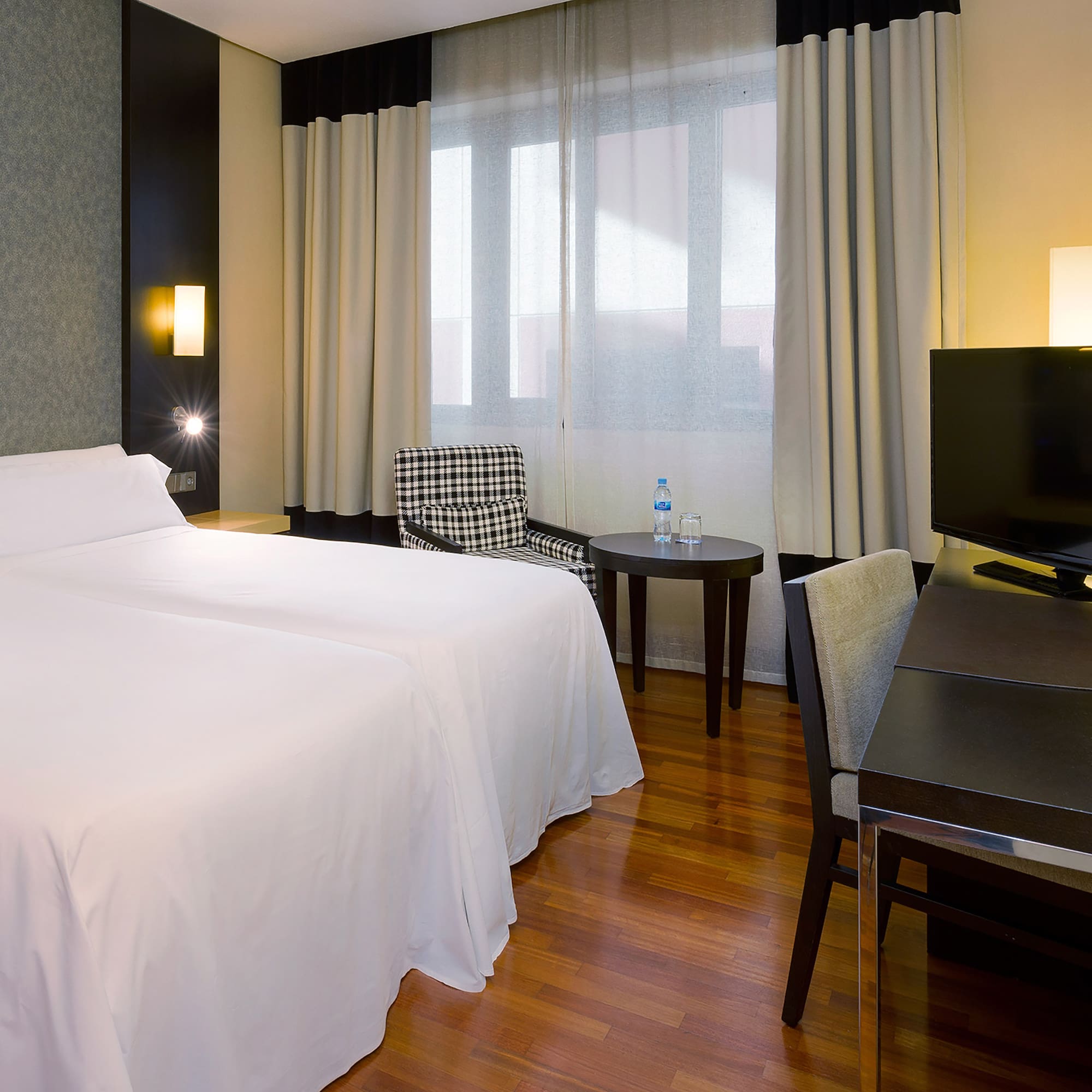 a room with a bed and a table and chairs