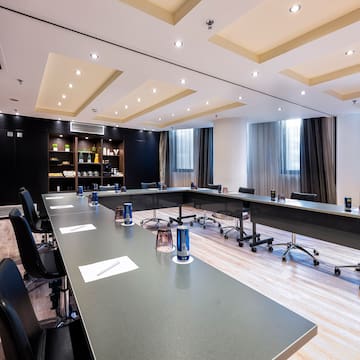 a conference room with a long table and chairs