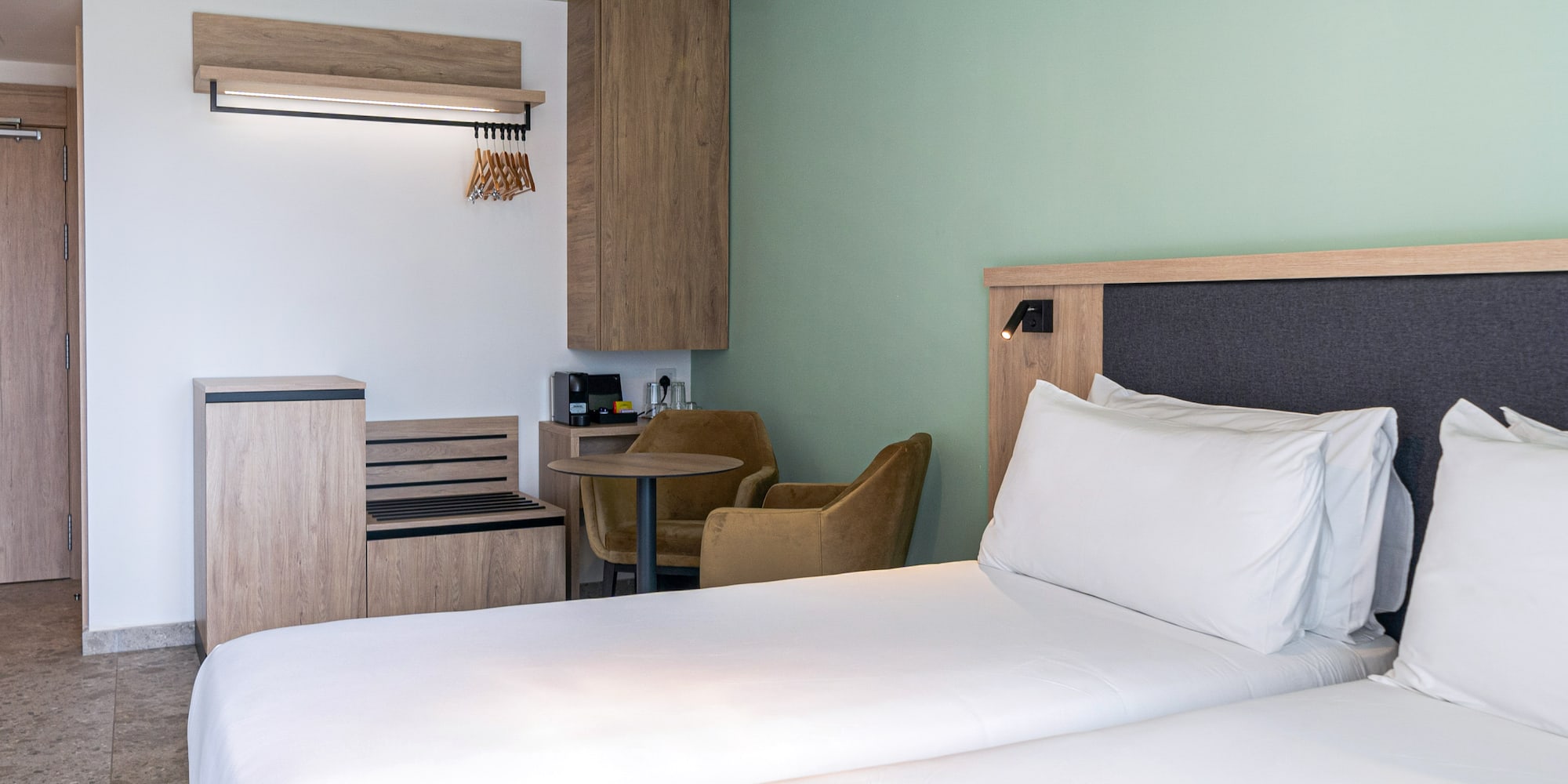 a room with two beds and a table