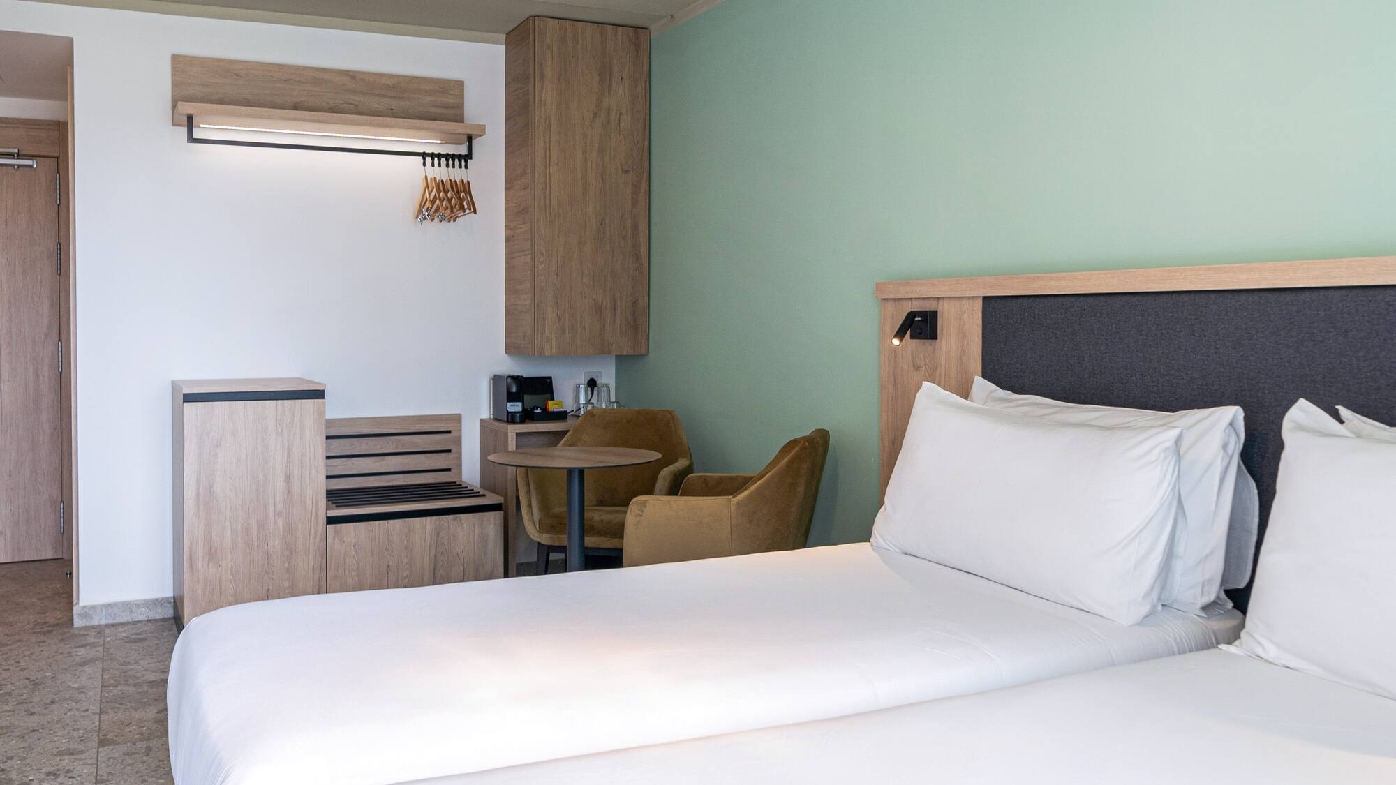 a room with two beds and a table