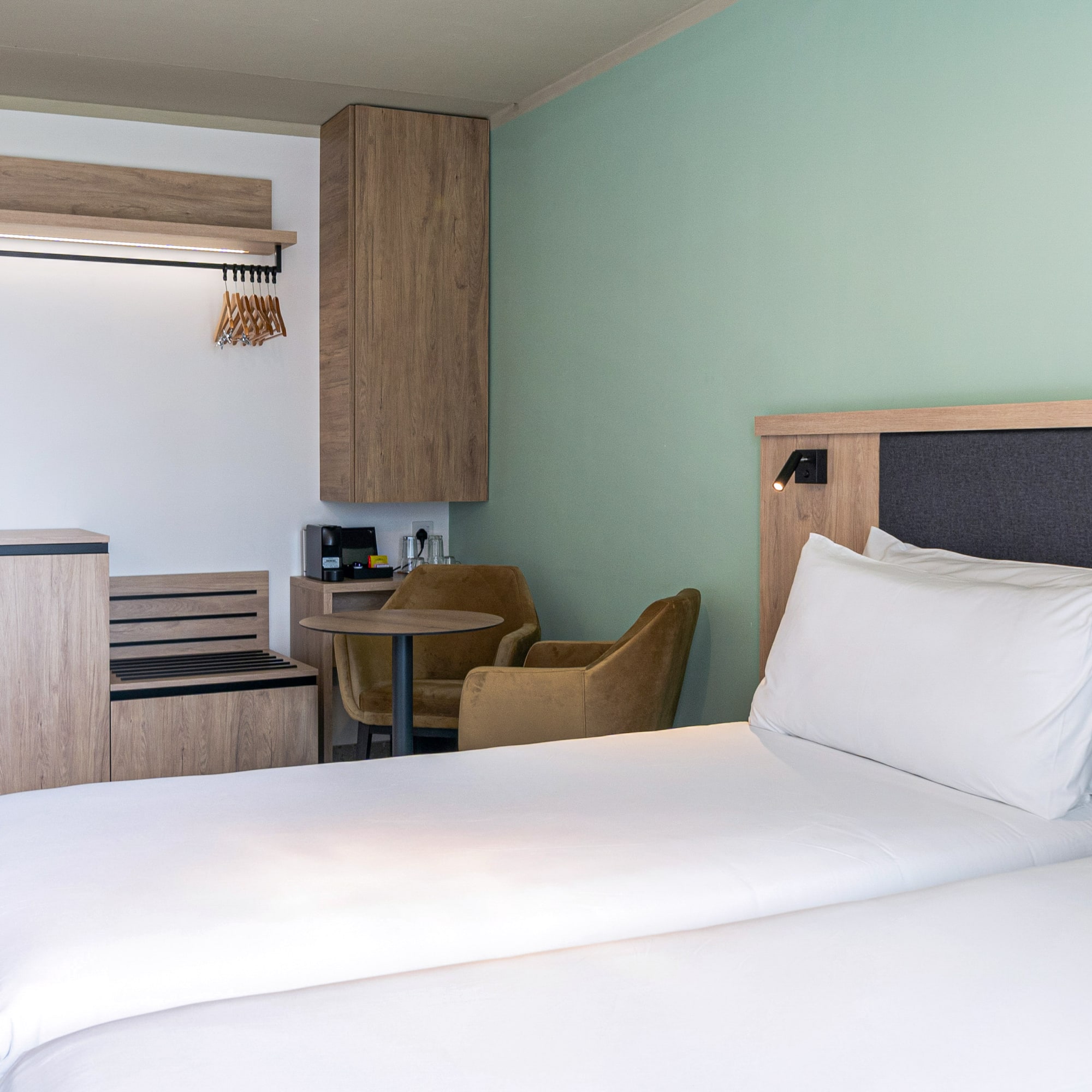 a room with two beds and a table