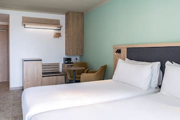 a room with two beds and a table