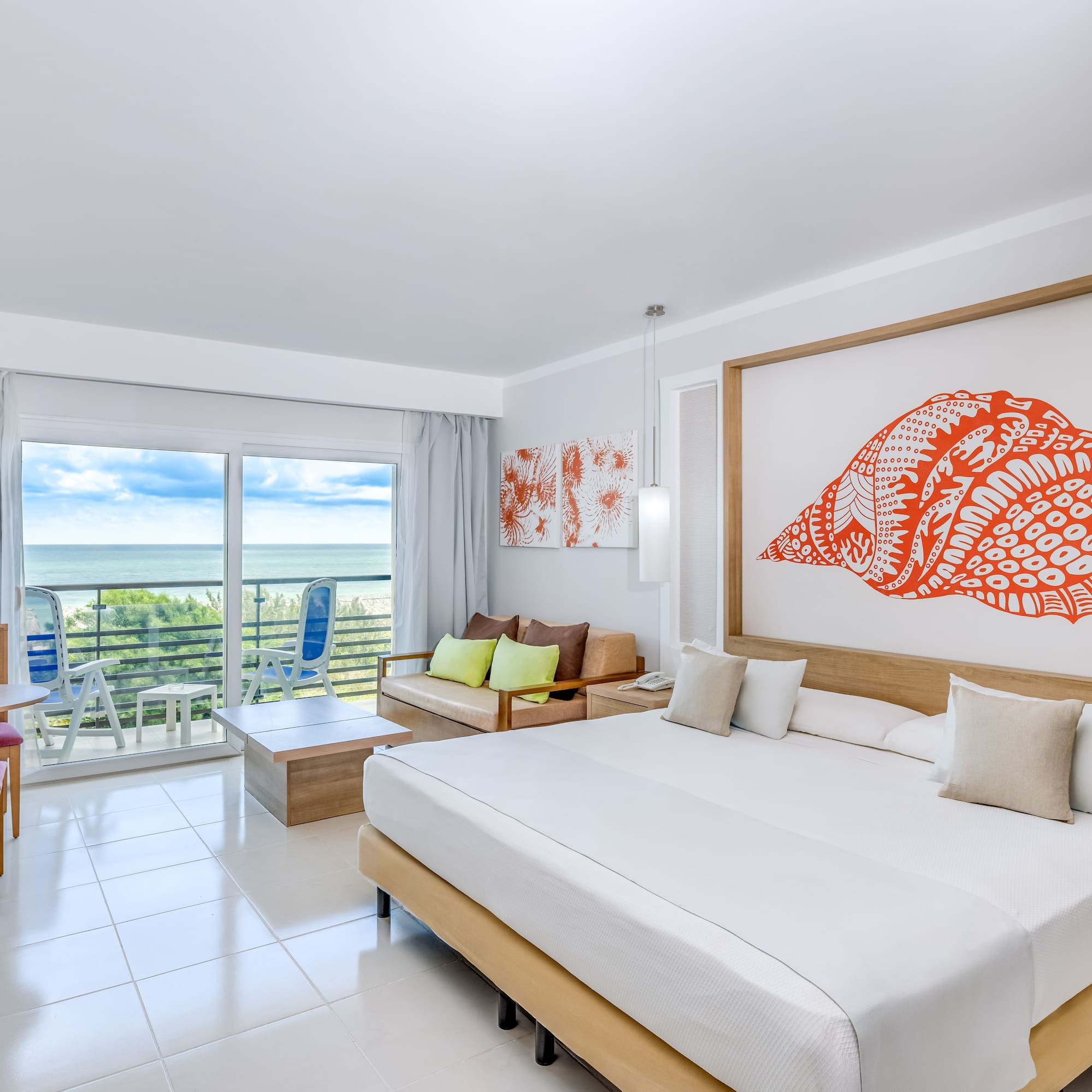 a room with a large bed and a large picture on the wall