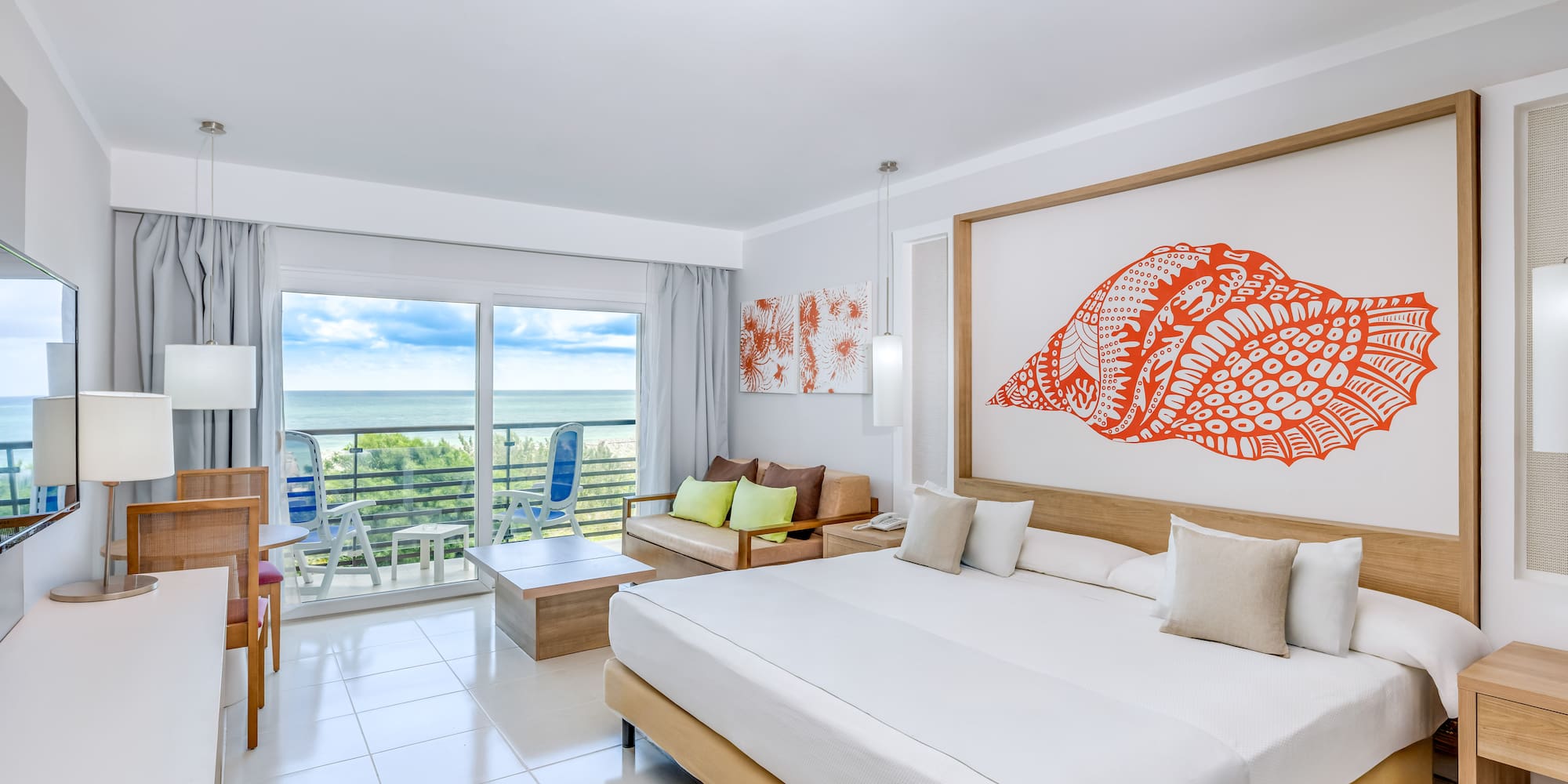 a room with a large bed and a large picture on the wall