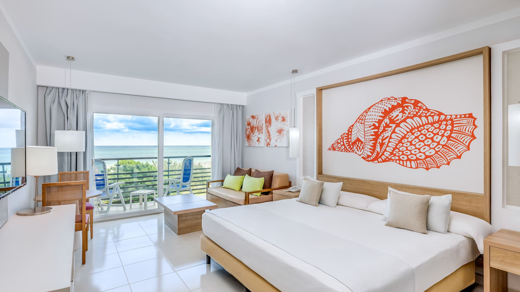 a room with a large bed and a large picture on the wall