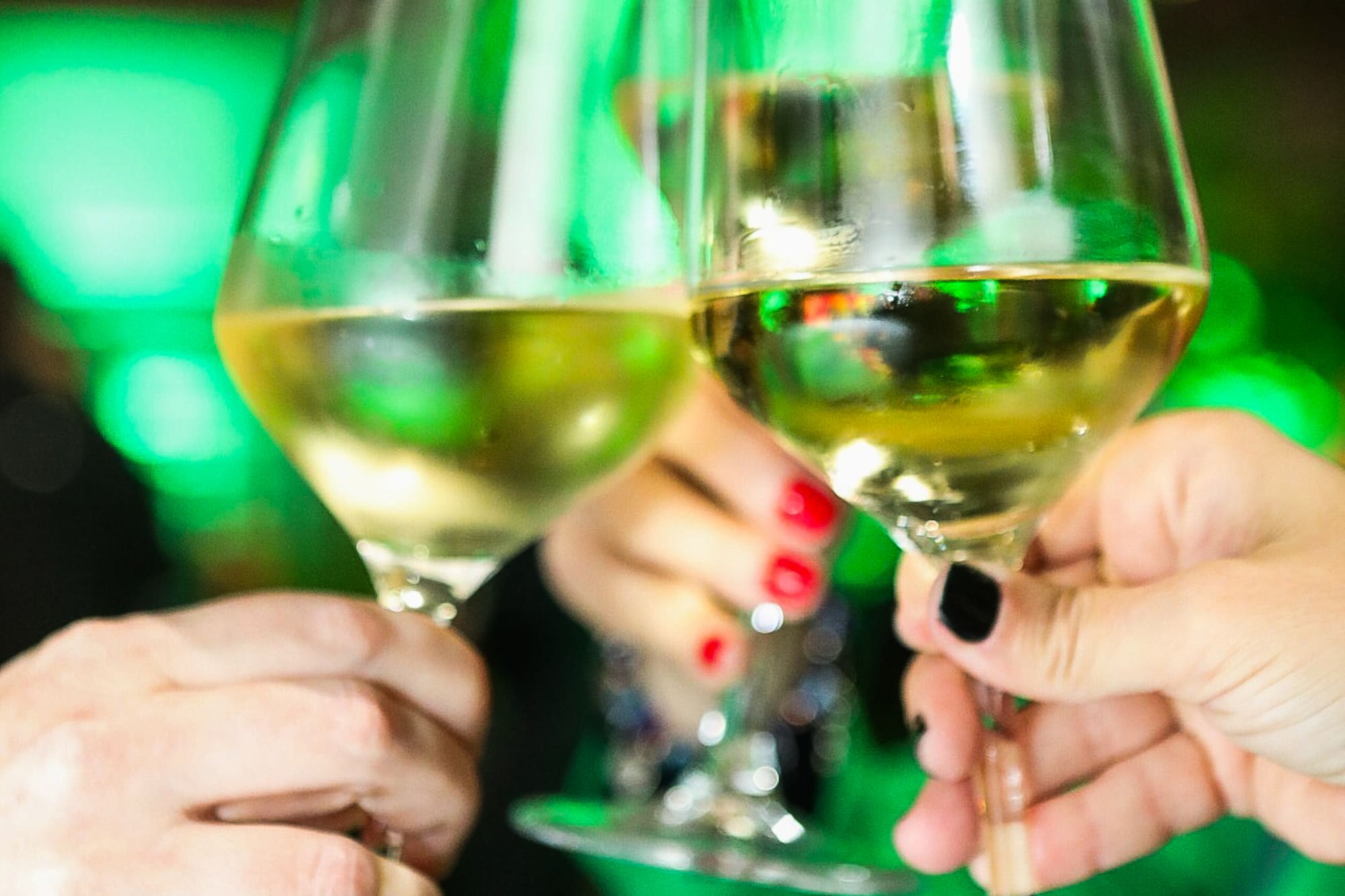 a group of people holding wine glasses