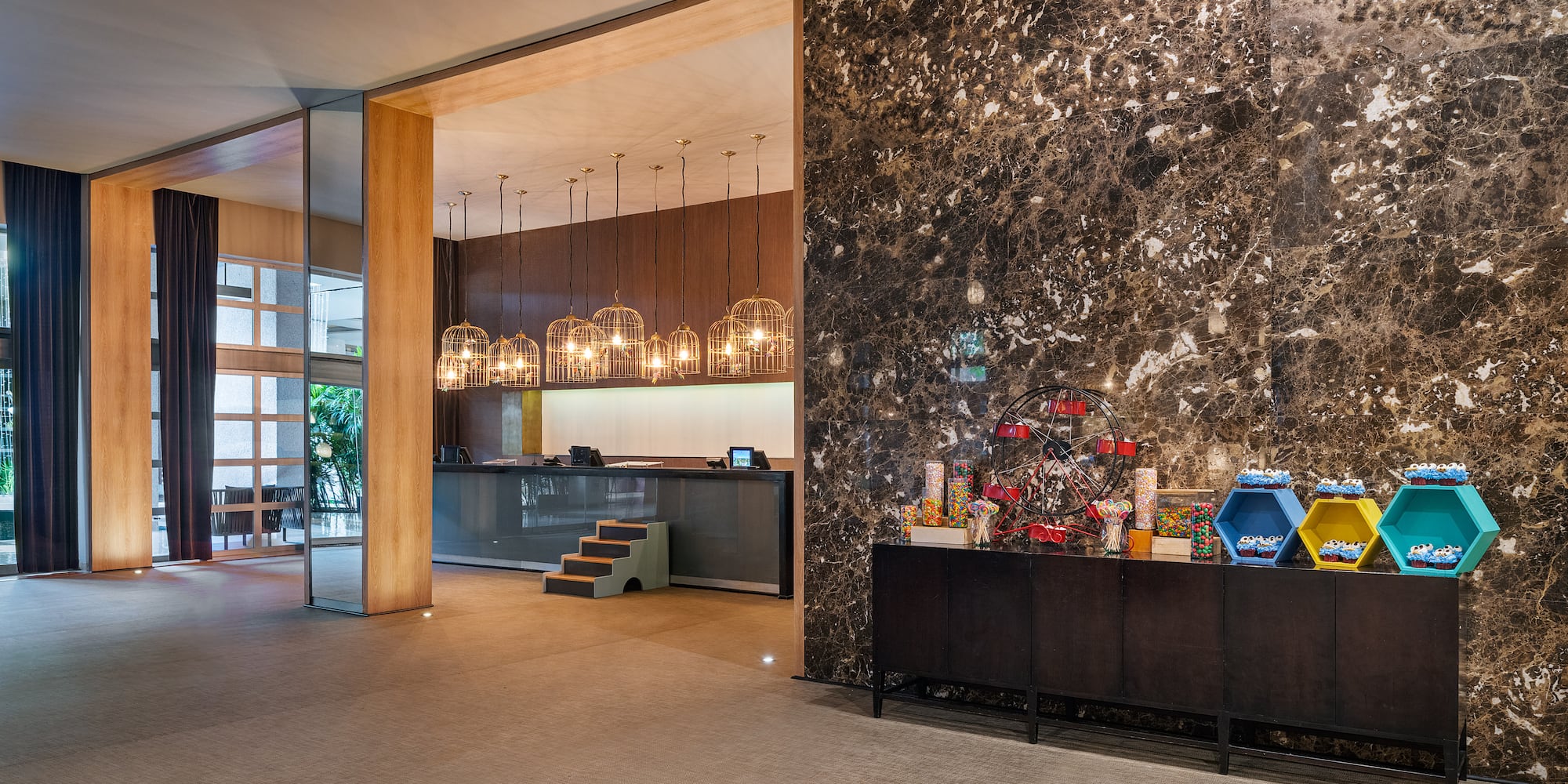 a lobby with a marble wall and a counter