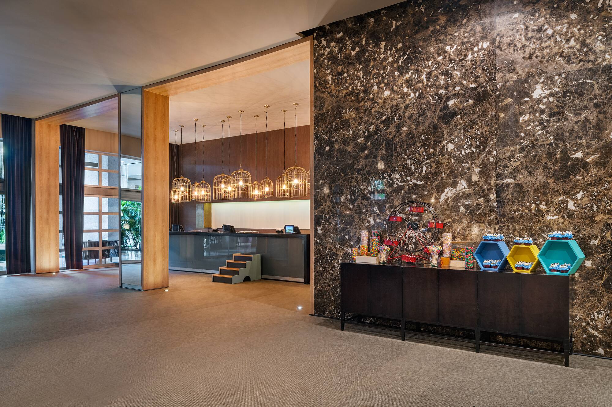 a lobby with a marble wall and a counter