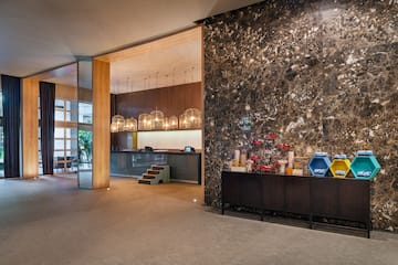 a lobby with a marble wall and a counter