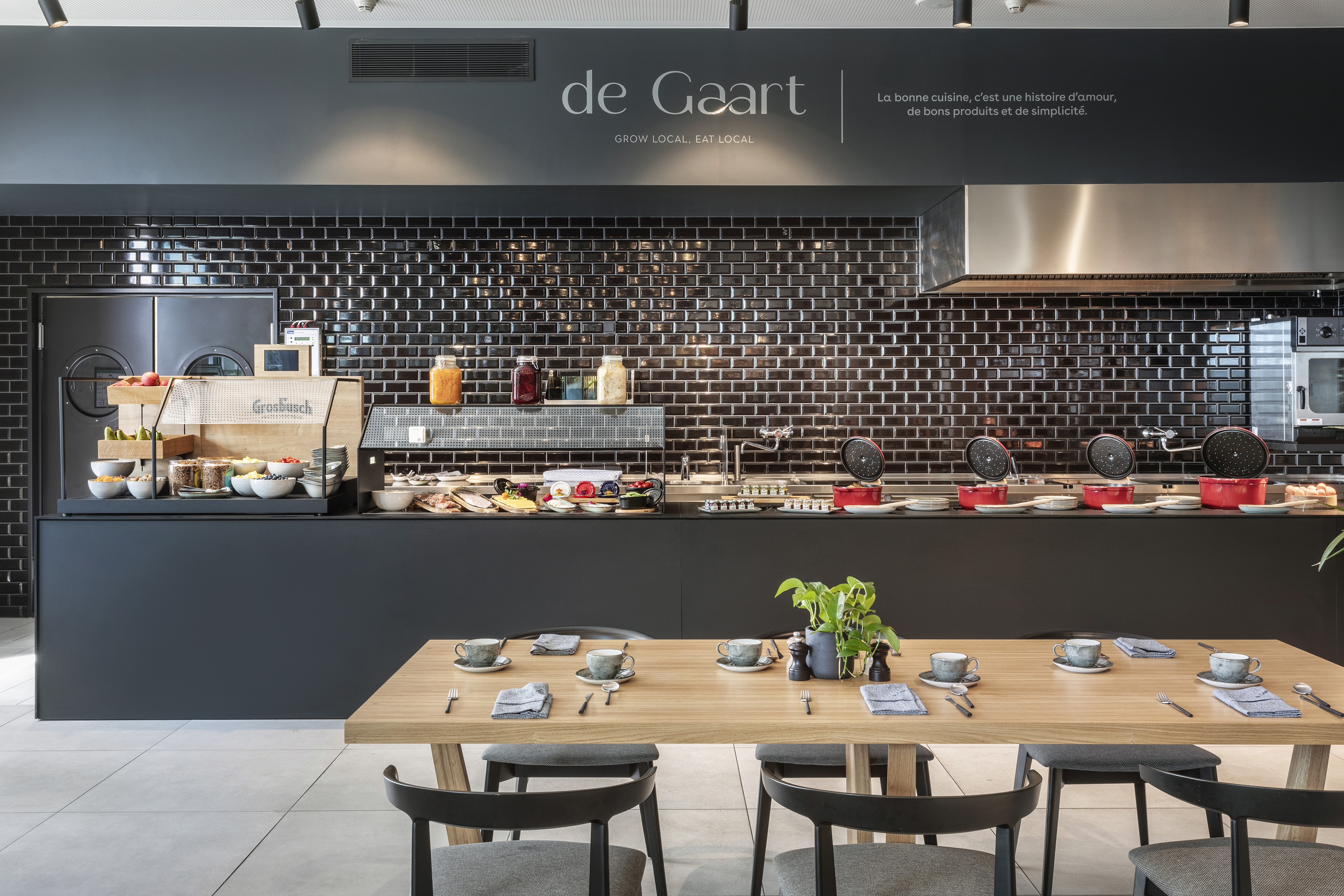 de Gaart modern breakfast buffet with local food, black tiles, and set table.