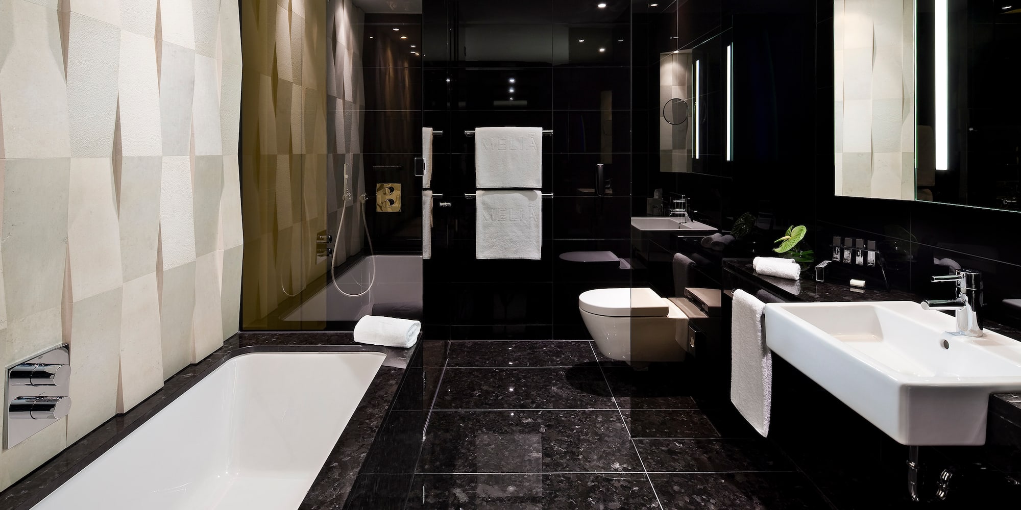 a bathroom with a black tile floor