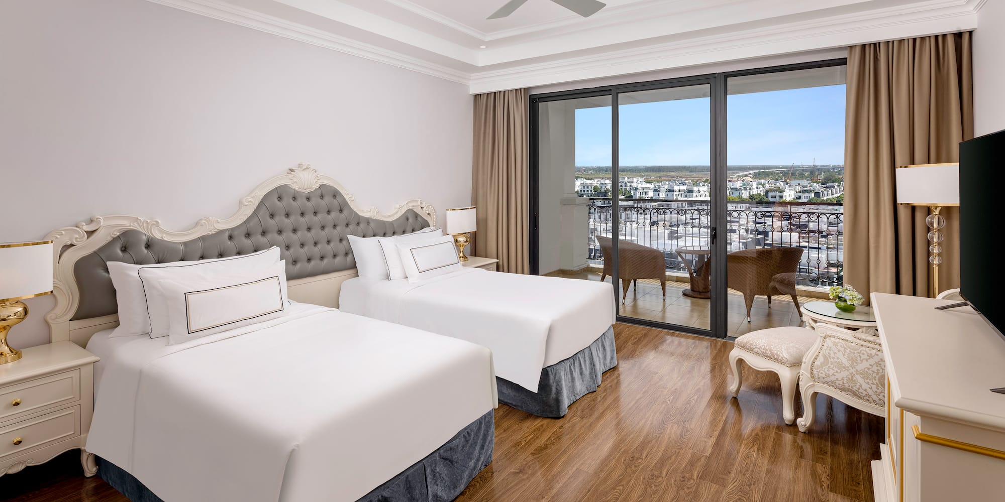 a room with two beds and a table and chairs