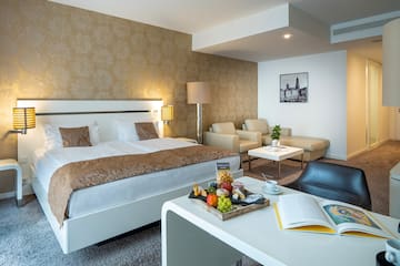a hotel room with a bed and a table