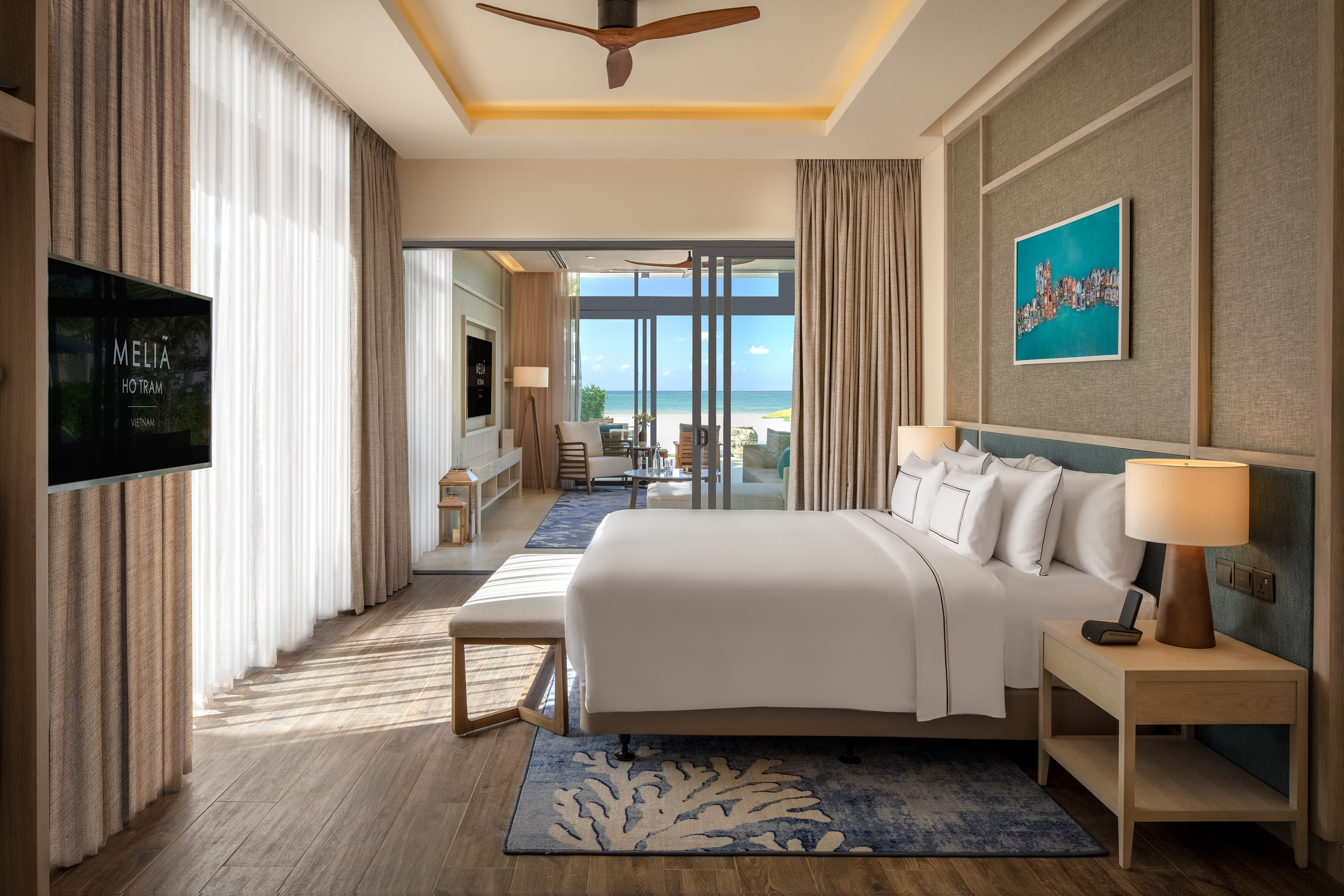 Melia Ho Tram hotel room with king bed, beach view, modern luxury.
